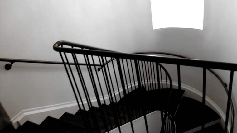 Curved stair with a steel picket guard