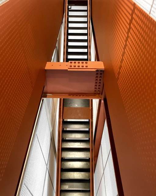 Orange stair in a perforated shaft