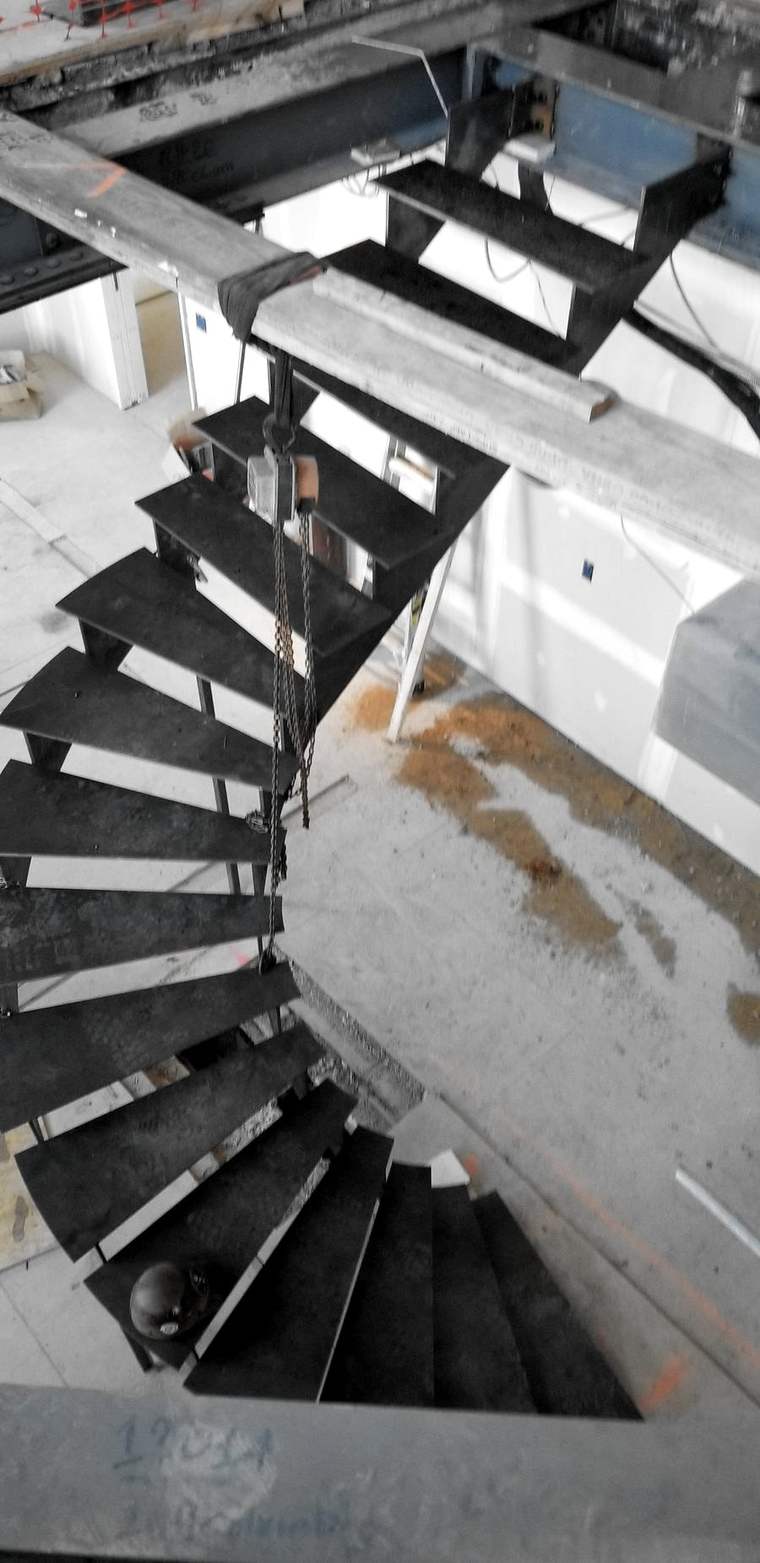 Looking down a dark steel spiral stair